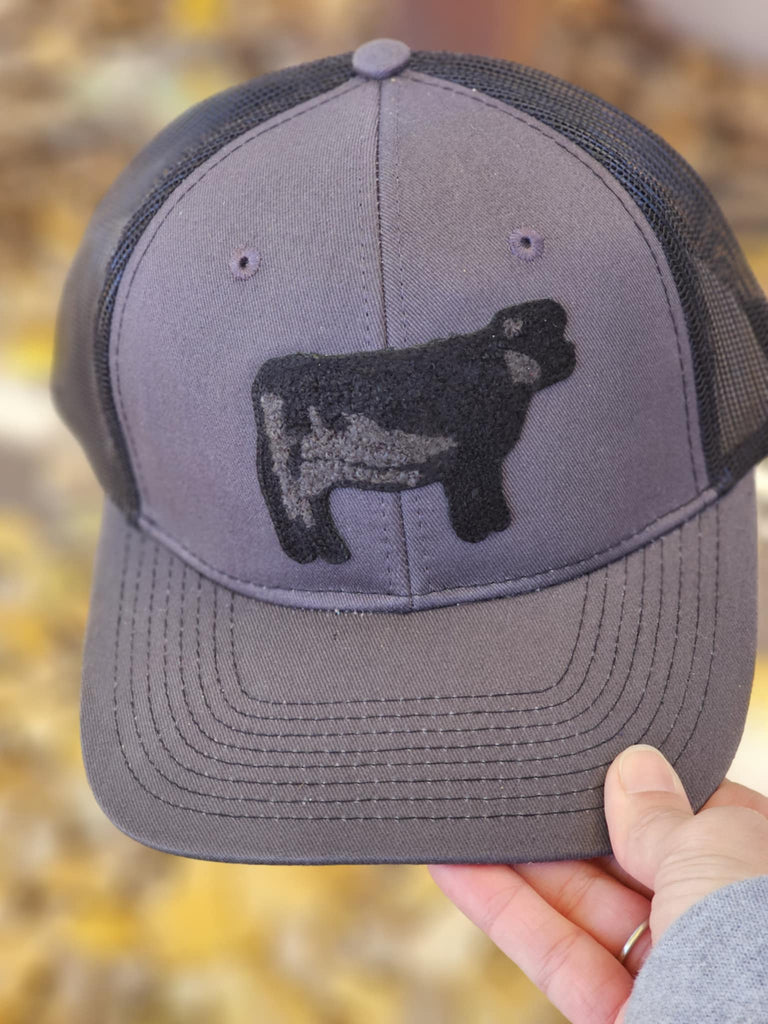 Cow Patch Dark Grey And Black Trucker Hat patch trucker hat The Cinchy Cowgirl