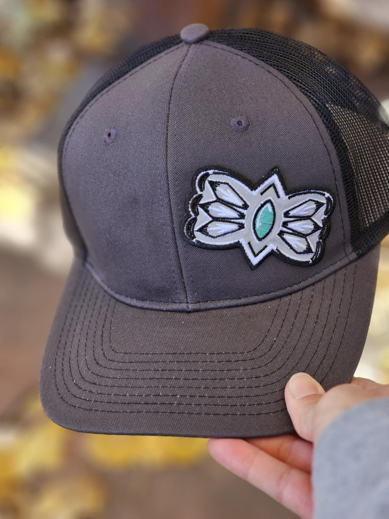 Grey And Turquoise Buckle Patch Set to the Side Dark Grey And Black Trucker Hat patch trucker hat The Cinchy Cowgirl