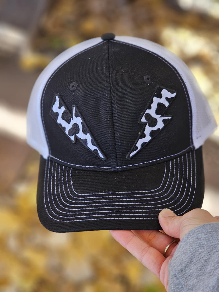 Cow Print Lightning Bolt Patches Black And White Trucker Hat patch trucker hat The Cinchy Cowgirl